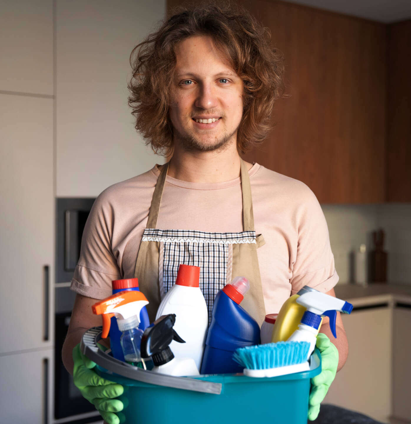 A man holding a bucket of cleaning supplies.